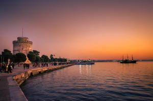 a view of a river with a tower in the distance at MoodSolutionsSkg in Thessaloniki