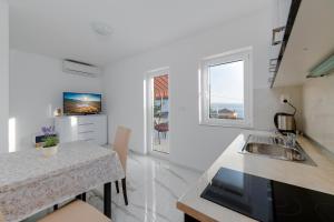 a kitchen with a sink and a counter top at Apartments Melita in Crikvenica
