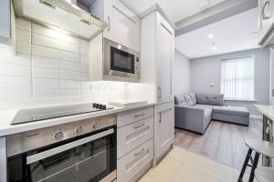 a kitchen with a stove and a couch in a room at HillTop View 'Sleeping 5 guests' in Derry Londonderry