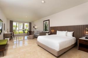 a bedroom with a large bed and a living room at Hyatt Regency Grand Reserve Puerto Rico in Rio Grande