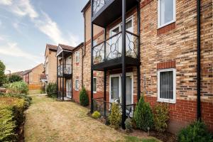 a brick house with a balcony on the side of it at Lakeside Reach in Doncaster