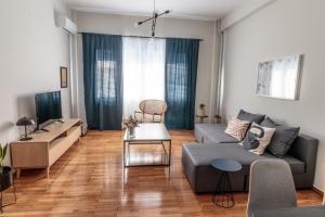 a living room with a couch and a table at Hamaretou Apartment in Sparti