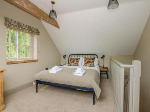 a bedroom with a bed and a window at The Hayloft at Warren House in Market Rasen