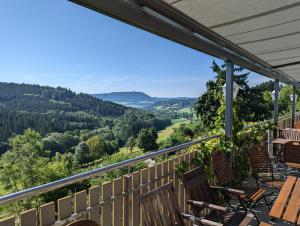 a balcony with chairs and a view of the mountains at Gasthof Hirsch in Waldstetten