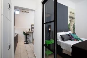 a small bedroom with a bed and a small kitchen at Apartment Deluxe Ana in Pula