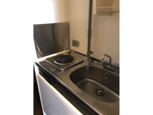 a kitchen with a stove and a sink at Hotel Yukita - Vacation STAY 20929v in Sapporo