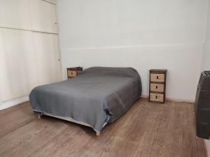 a bedroom with a bed and two boxes on the floor at La Emilia in San Pedro