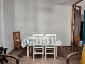a dining room table with two chairs and a table cloth at La Emilia in San Pedro