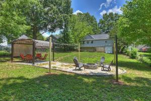 a yard with chairs and a fire pit and a house at 3BR/2 Bath with King and outside fire Pit in Concord
