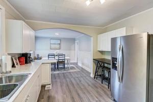 a kitchen with white cabinets and a stainless steel refrigerator at 3BR/2 Bath with King and outside fire Pit in Concord