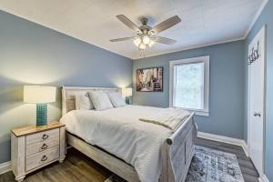 a bedroom with a bed and a ceiling fan at 3BR/2 Bath with King and outside fire Pit in Concord