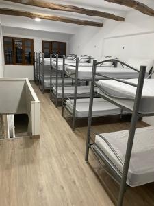 a row of bunk beds in a room at Albergue y Gelateria il nonno in Sarria