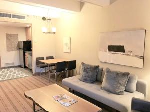 a living room with a couch and a table at Penthouse Ski-In Ski-Out Above Sheraton 1bd 1.5ba in Steamboat Springs