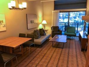 a living room with a couch and a table at Penthouse Ski-In Ski-Out Above Sheraton 1bd 1.5ba in Steamboat Springs
