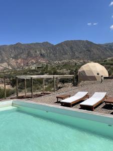 a swimming pool next to a tent and a tent at Denmoza Eco Lodge in Potrerillos