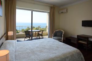 Postel nebo postele na pokoji v ubytování Sun Beach