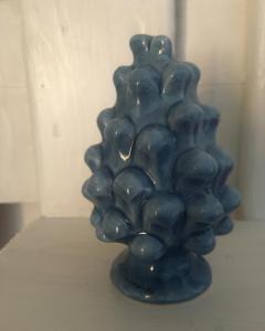 a blue glass vase sitting on a table at House il Conte in Palermo