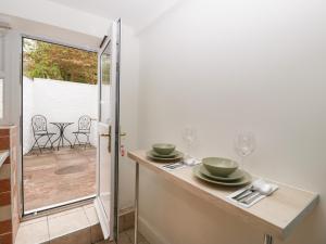 a kitchen with a table with plates and wine glasses at The Cwtch in Abergavenny