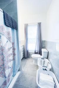 a bathroom with a toilet and a sink at The Cedar Chateau in Niagara Falls