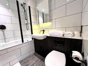 a bathroom with a toilet and a sink at Hotel Apartment Two Bedroom Ferrum Wembley Park in London