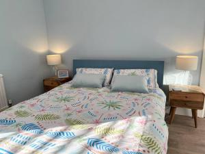 a bedroom with a large bed with two pillows at Beach home with garden, close to New Forest in Bournemouth