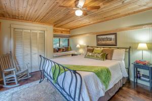 a bedroom with a bed and a ceiling fan at Magical Mountain Riverfront Retreat near Blue Ridge Georgia with Unforgettable Views! in Mineral Bluff