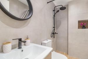 a bathroom with a white sink and a mirror at Greek Dream Homes Thimari in Sounio +28 photos