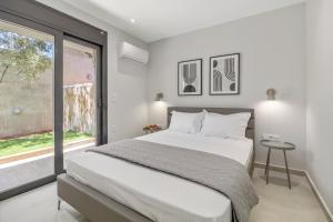 a bedroom with a large bed and a window at Greek Dream Homes Thimari in Sounio