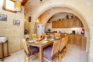 a kitchen with a table and chairs in a room at Lellux Holiday Home in Nadur
