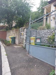 um portão para uma casa com uma parede de pedra em Apartman Benjamin em Tuzla