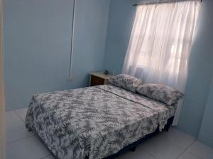 Postel nebo postele na pokoji v ubytování Avocado Suites