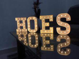 a lit up sign that says hope on a table at Pretty Apartment HOEStel Bacaret! in Cancún