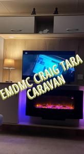 una televisione con un cartello che legge "Campo di atterraggio carihad" di EMDMC Craig Tara Caravan ad Ayr