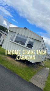 a caravan is parked on the side of a road at EMDMC Craig Tara Caravan in Ayr