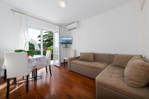 a living room with a couch and a table at Apartments Melita in Crikvenica