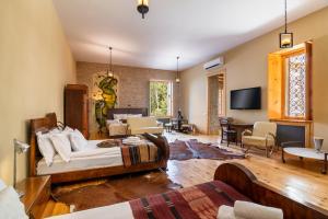 a living room with two beds and a tv at Castle in Old Town in Tbilisi City