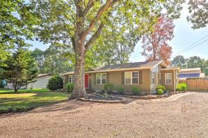 a house with a tree in the driveway at Charming Retreat Less Than 2 Mi to Cranfield Marina! in Mountain Home