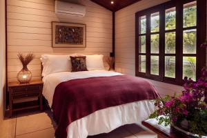 Cama ou camas em um quarto em Embaúba Boutique Hotel