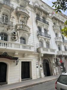 a large white building with balconies on a street at Appartemet haut standing in Tunis