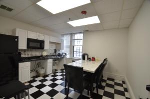 a kitchen with a table and a checkered floor at Michie House in College Hill in Providence