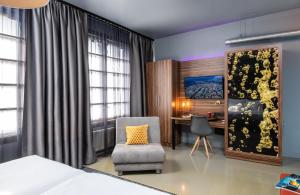 a bedroom with a bed and a desk and a chair at NYX Hotel Prague by Leonardo Hotels in Prague