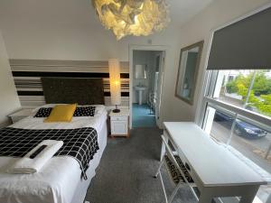 A bed or beds in a room at Golden Triangle Rooms