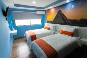 a hotel room with two beds and a painting on the wall at Hotel Boutique Mardeka in Orizaba