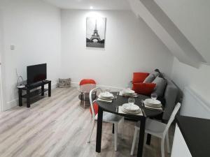 a living room with a table and a couch at Remarkable 2-Bed Apartment in Chelmsford in Chelmsford