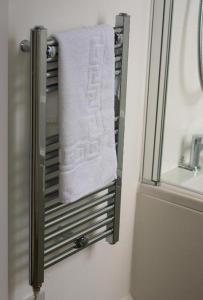 a towel hanging on a towel rack in a bathroom at Remarkable 2-Bed Apartment in Chelmsford in Chelmsford