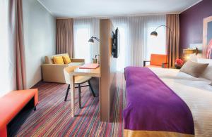 Ein Bett oder Betten in einem Zimmer der Unterkunft Leonardo Hotel Munich City South