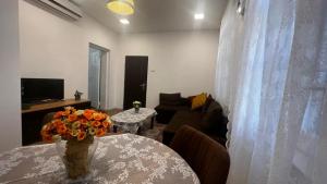 a living room with a table with a vase of flowers at Ben Gurion (1) 42 in Haifa