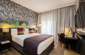 a hotel room with a large bed and a desk at Leonardo Boutique Hotel Madrid in Madrid