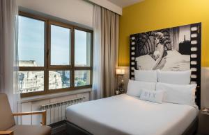 a hotel room with a bed and a window at NYX Hotel Milan by Leonardo Hotels in Milan