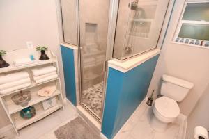 a small bathroom with a shower and a toilet at Tropical Hideaway in Port Orange